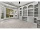 Office with large built-in bookshelves, neutral carpet, and a bay window for natural light at 3699 Canyon Ridge Ne Ct, Brookhaven, GA 30319