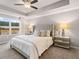 Bright bedroom features tray ceiling, ceiling fan, plush carpet, and natural light from a large window at 5623 Hislop Ln # 84, Mableton, GA 30126