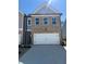 Two-story brick home with a two-car garage, grey siding and modern architectural details at 5623 Hislop Ln # 84, Mableton, GA 30126