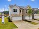 Beautifully constructed townhomes, each with a two-car garage and professionally landscaped front yards at 5623 Hislop Ln # 84, Mableton, GA 30126