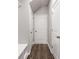 Hallway with neutral gray paint and dark hard surface flooring and white doors at 5623 Hislop Ln # 84, Mableton, GA 30126