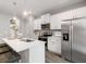Modern kitchen features a center island, stainless steel appliances, and white cabinetry at 5623 Hislop Ln # 84, Mableton, GA 30126