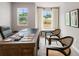 Spacious office with two large windows and elegant, dark-wood furniture at 5623 Hislop Ln # 84, Mableton, GA 30126