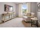 Relaxing sitting room with plush chair, console table, and large window letting in natural light at 5623 Hislop Ln # 84, Mableton, GA 30126