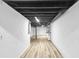 Large unfinished basement with concrete walls, painted ceilings, and wood-look flooring at 6243 David Sw Ln, Mableton, GA 30126