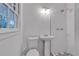 Bathroom with a pedestal sink and subway-tiled shower at 6243 David Sw Ln, Mableton, GA 30126
