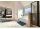 Bright main bathroom with a soaking tub, glass-enclosed shower, and doorway to the main bedroom at 817 Nevis Way, Mcdonough, GA 30253