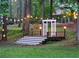 A whimsical outdoor space showcasing a stage with a white pergola, string lights and a manicured lawn at 2900 Orchard Sw Rd, Conyers, GA 30094