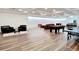 Spacious basement area featuring seating, a pool table, a ping pong table and wood-look flooring at 2900 Orchard Sw Rd, Conyers, GA 30094