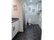 Stylish bathroom with black-and-gold floors, modern fixtures, and white cabinets for a clean, contemporary look at 2900 Orchard Sw Rd, Conyers, GA 30094