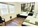 Cozy bedroom with two twin beds, wood floors, natural light from two windows, and a forest themed wall art at 2900 Orchard Sw Rd, Conyers, GA 30094