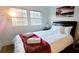 Sun-filled bedroom with a view from the windows, a queen-sized bed, and a plush accent blanket at 2900 Orchard Sw Rd, Conyers, GA 30094