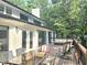 Spacious deck perfect for outdoor dining with comfortable seating and scenic views of the surrounding trees at 2900 Orchard Sw Rd, Conyers, GA 30094