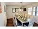 Elegant dining room with a long table, stylish chairs, a modern chandelier, and ample natural light at 2900 Orchard Sw Rd, Conyers, GA 30094