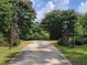 Gated entrance with beautiful flowering trees lining the driveway at 2900 Orchard Sw Rd, Conyers, GA 30094
