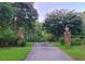 Gated entrance with beautiful flowering trees lining the driveway at 2900 Orchard Sw Rd, Conyers, GA 30094