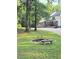 Beautiful home with a circular fire pit and stone benches at 2900 Orchard Sw Rd, Conyers, GA 30094
