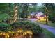 Well-maintained home featuring beautiful landscaping, charming exterior lighting, and a welcoming driveway at 2900 Orchard Sw Rd, Conyers, GA 30094
