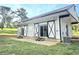 Modern exterior with sleek sliding doors, white siding, and black trim, plus a grassy lawn and plenty of parking at 2900 Orchard Sw Rd, Conyers, GA 30094
