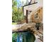 Stunning stone and siding exterior showcasing a rock waterfall, pond, and beautiful landscape at 2900 Orchard Sw Rd, Conyers, GA 30094