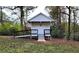 Quaint white outbuilding nestled among trees, featuring a ramp and steps for easy access at 2900 Orchard Sw Rd, Conyers, GA 30094