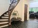 Welcoming foyer with a curved staircase, elegant decor, and tile flooring leading to a spacious living area at 2900 Orchard Sw Rd, Conyers, GA 30094