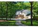 Charming two-story home with stone accents, a covered porch, and a welcoming driveway surrounded by lush landscaping at 2900 Orchard Sw Rd, Conyers, GA 30094