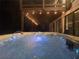 Relaxing hot tub with lights for nighttime enjoyment and covered space for privacy and protection from the elements at 2900 Orchard Sw Rd, Conyers, GA 30094