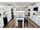 Modern kitchen with white cabinets, black appliances, a center island, and hardwood floors at 2900 Orchard Sw Rd, Conyers, GA 30094