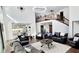 Spacious living room with high ceilings, leather sofas, and views of the modern kitchen and staircase at 2900 Orchard Sw Rd, Conyers, GA 30094