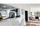 Bright, open-concept space with a modern kitchen, dining area, and staircase with abundant natural light at 2900 Orchard Sw Rd, Conyers, GA 30094