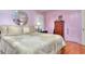 Bedroom featuring hardwood floors, a decorative ceiling fan, large bed, and two doors at 304 Warren Se St, Atlanta, GA 30317