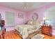 Bedroom with wood floors, a decorative ceiling fan, and a large bed with a decorative bedspread at 304 Warren Se St, Atlanta, GA 30317