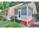 View of the exterior featuring a screened entrance, carport, and fenced yard at 304 Warren Se St, Atlanta, GA 30317