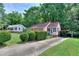 Charming home featuring lush landscaping, a cozy porch, and convenient carport at 304 Warren Se St, Atlanta, GA 30317