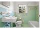 Retro bathroom featuring green tiles, a bathtub, toilet and sink at 3073 Henderson Mill Rd, Atlanta, GA 30341