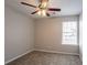 An empty carpeted bedroom featuring a window and ceiling fan at 3870 Golfe Links Dr, Snellville, GA 30039