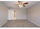 A view of a carpeted bedroom looking into the connected bathroom with an open door at 3870 Golfe Links Dr, Snellville, GA 30039