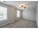 Light filled bedroom featuring neutral walls and carpet with two windows at 3870 Golfe Links Dr, Snellville, GA 30039