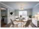 Elegant dining room featuring modern chandelier, round glass table, and stylish white chairs, perfect for entertaining at 3870 Golfe Links Dr, Snellville, GA 30039