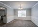 Dining room with chandelier, carpet, wainscoting and view of the kitchen at 3870 Golfe Links Dr, Snellville, GA 30039