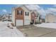 Attractive two-story home with two-car garage, surrounded by a snowy landscape and a well-maintained lawn at 3870 Golfe Links Dr, Snellville, GA 30039
