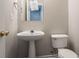 Bathroom with pedestal sink, toilet, and neutral paint at 3870 Golfe Links Dr, Snellville, GA 30039