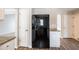 Kitchen with black refrigerator, granite countertops, and wood-look flooring at 3870 Golfe Links Dr, Snellville, GA 30039