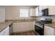 Well-equipped kitchen with granite counters, white cabinets, and modern stainless steel appliances at 3870 Golfe Links Dr, Snellville, GA 30039