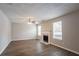 Living room featuring fireplace, wood-look flooring, and fan at 3870 Golfe Links Dr, Snellville, GA 30039