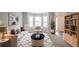 Bright living room with bay windows, neutral decor, plush seating, and stylish accents, creating an inviting space at 3870 Golfe Links Dr, Snellville, GA 30039