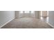 Spacious carpeted living room with large windows and natural light at 3870 Golfe Links Dr, Snellville, GA 30039