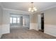 View of living room and dining room with neutral walls and trim at 3870 Golfe Links Dr, Snellville, GA 30039