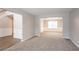 Living room with adjacent dining room showing carpet and decorative trim at 3870 Golfe Links Dr, Snellville, GA 30039